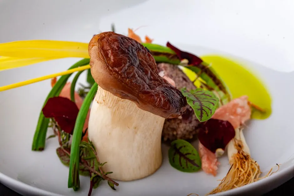 A gourmet dish featuring a beautifully presented mushroom with vibrant garnishes on a white plate.
